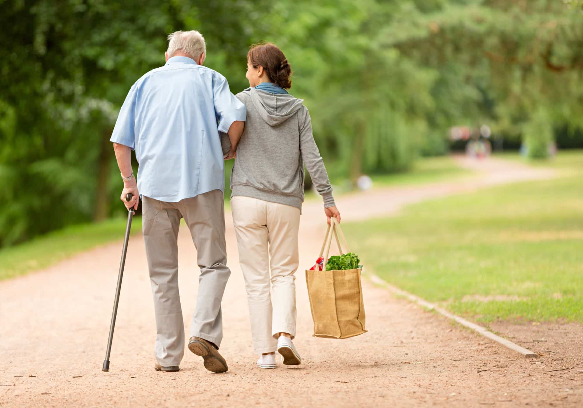 a man and woman walking on a path